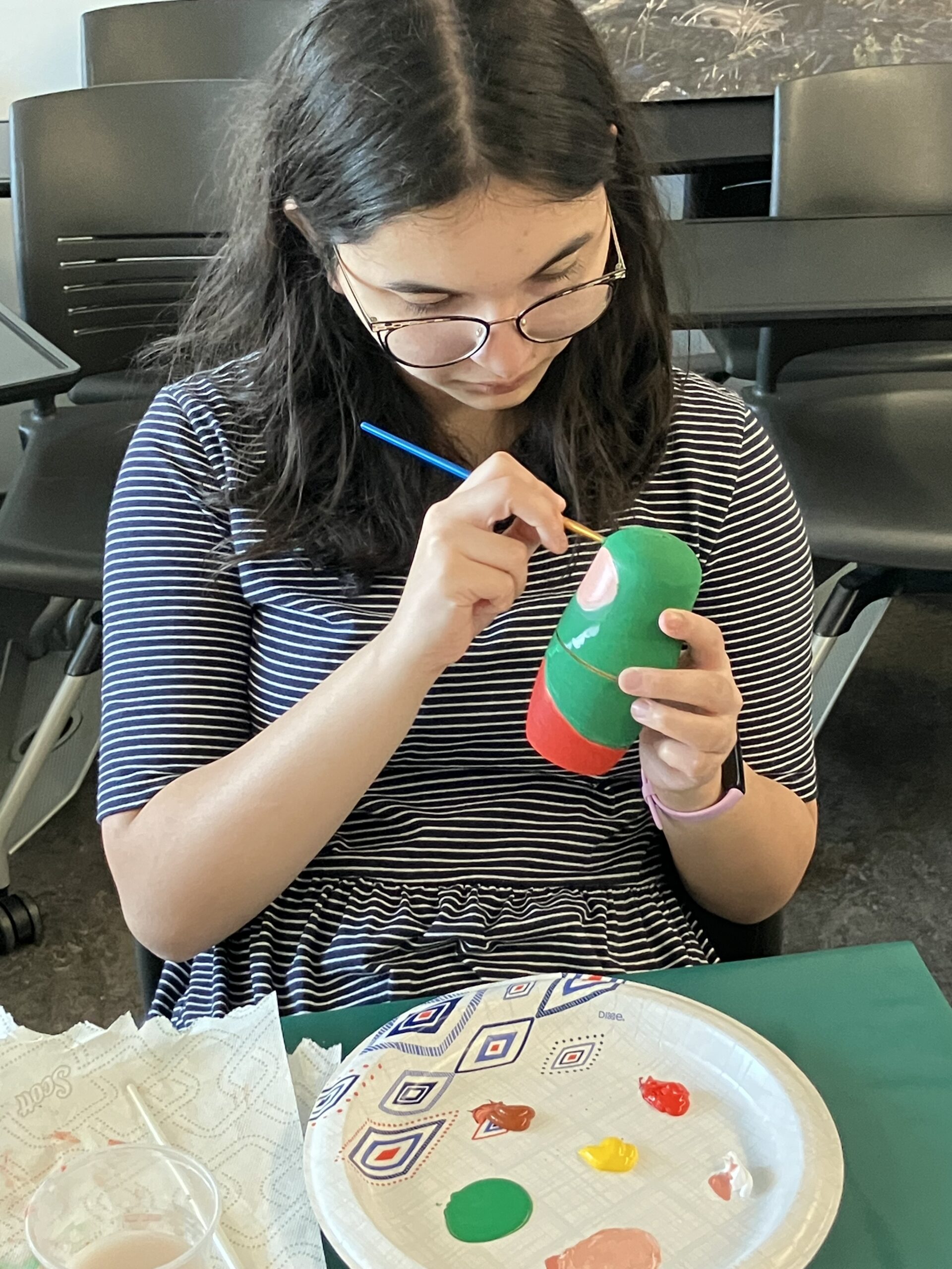 Student painting Russian doll